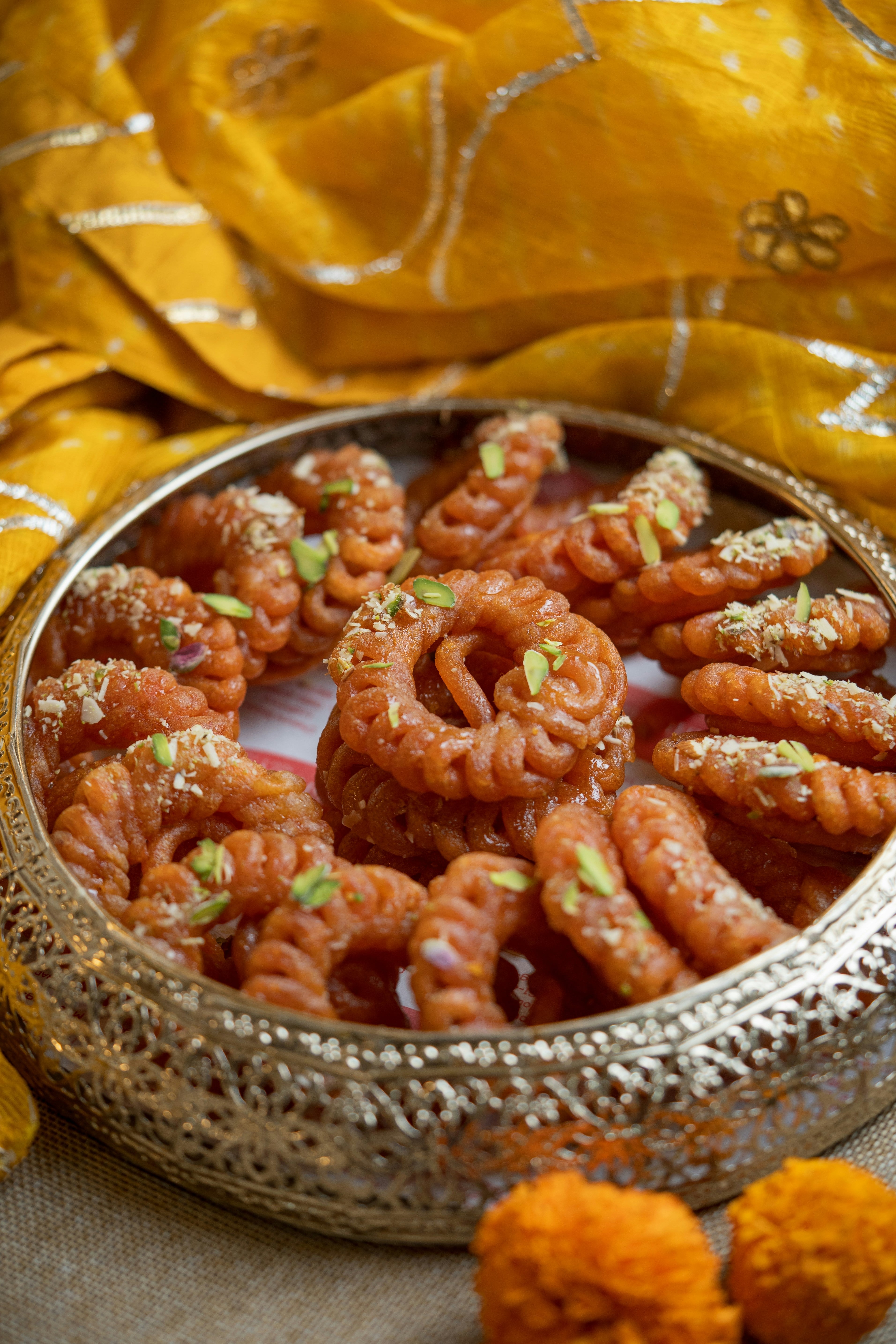 Indian sweets in a pierced silver bowl