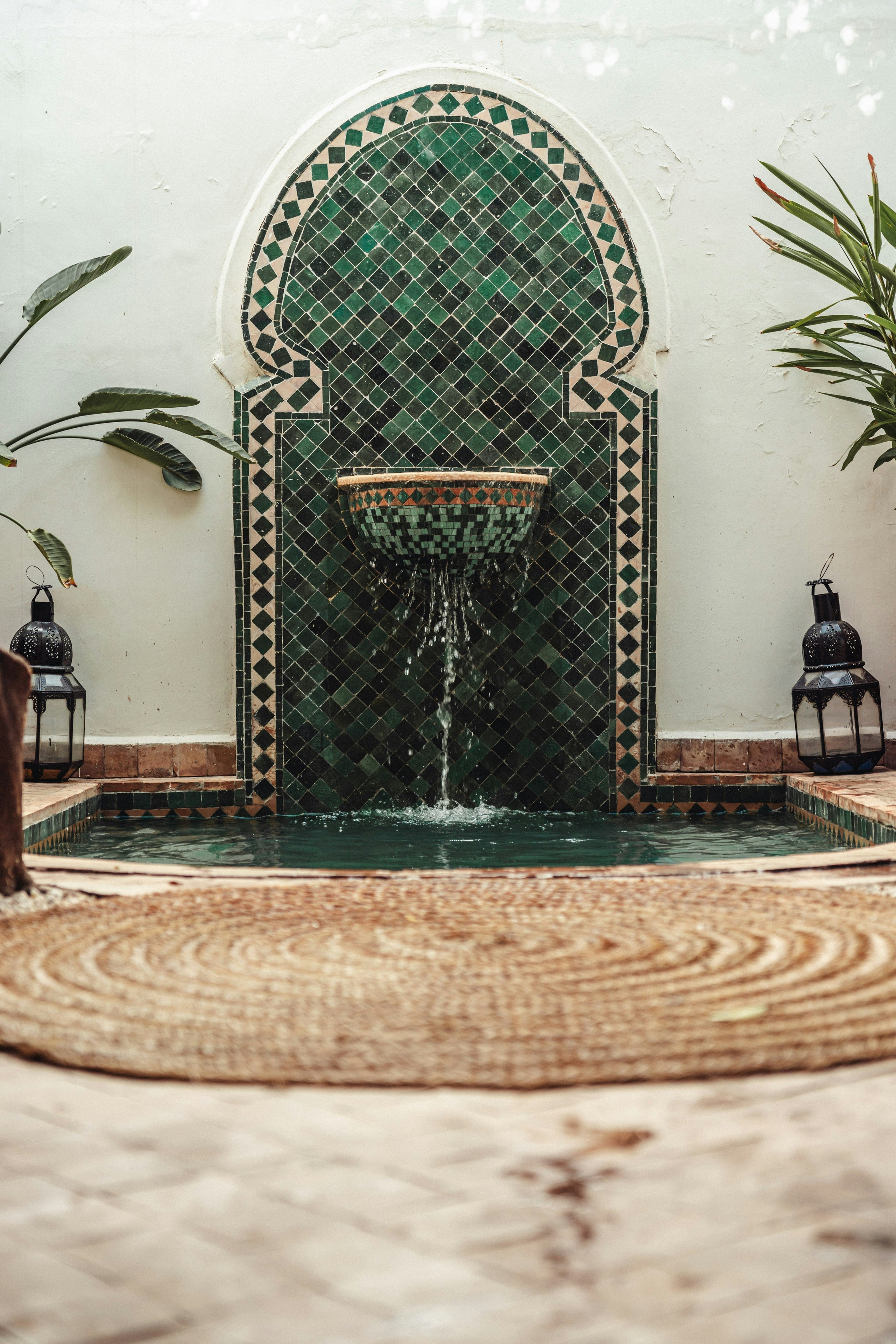 A zellige fountain in a white courtyard, Marrakech