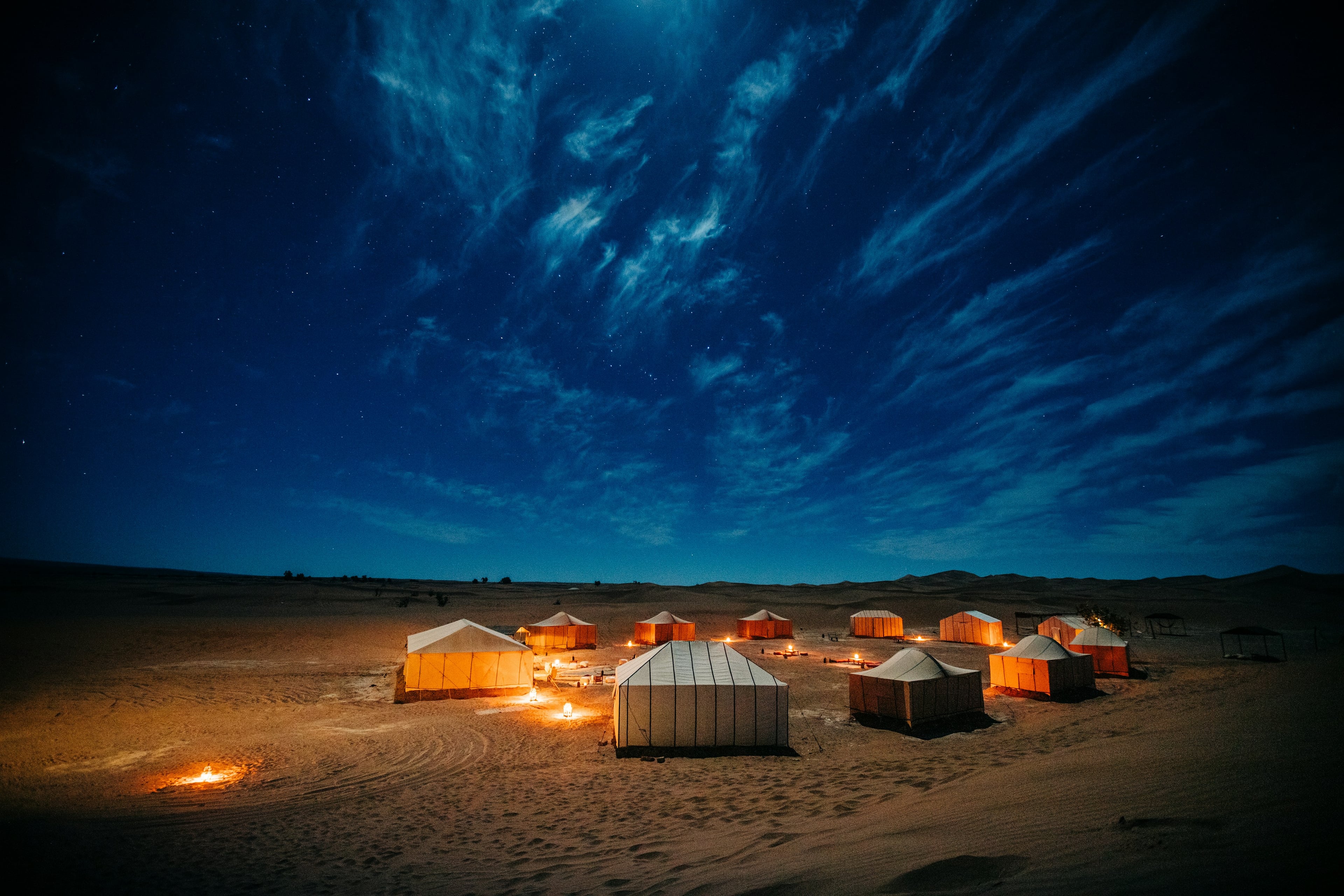 A desert camp beneath a sky full of stars