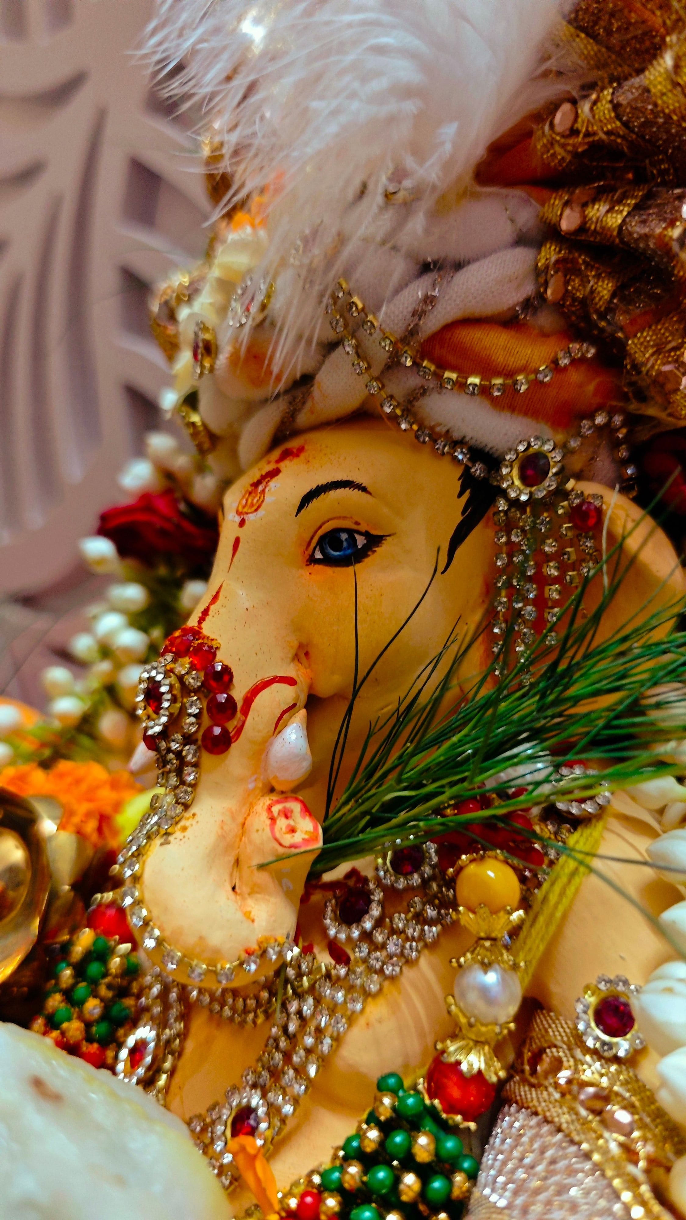 A Ganesha idol adorned with jewels and flowers